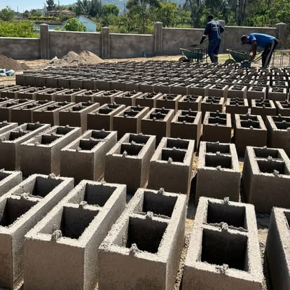 Workers making concrete blocks